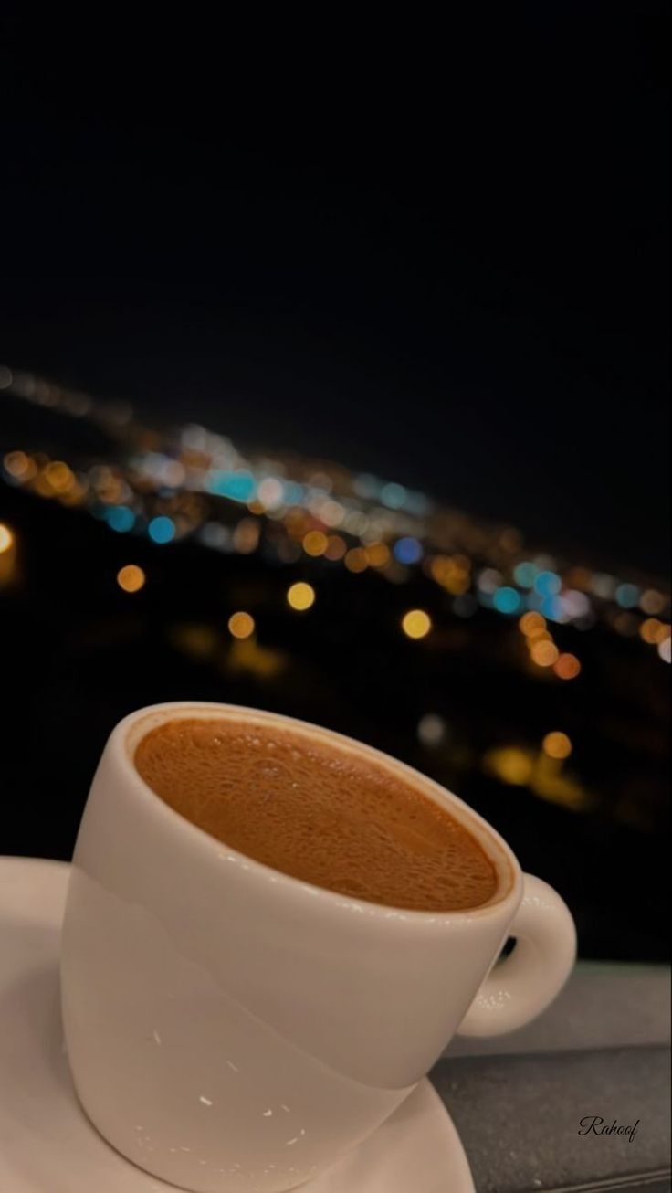 a cup of coffee sitting on top of a white saucer