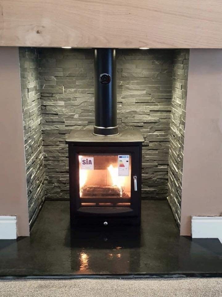 a wood burning stove sitting inside of a room