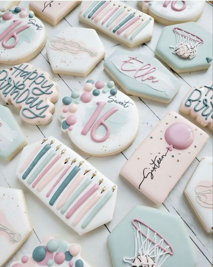 decorated cookies are arranged on the table for someone's 30th birthday party in pastel blue, pink and white