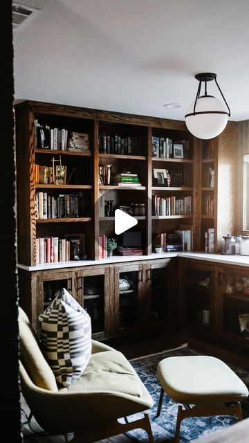 a living room filled with furniture and bookshelves next to a kitchen counter top