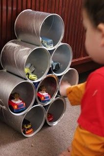 a young boy is playing with some metal tubes