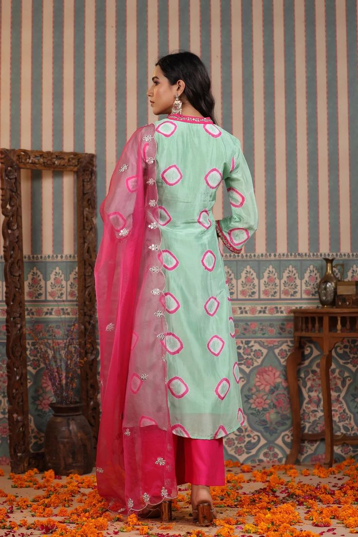 A timeless wardrobe essential, this mint green suit set is crafted from muslin fabric and features handwork that is sure to captivate. Accompanied with an organza dupatta, this set exudes elegance and sophistication. Relaxed enough for every day and luxurious enough for special occasions, this is an exclusive piece that will never go out of style. No. of pieces - 3 piece set. Color - Green and Pink. Fabric - Muslin. Washing Instructions - Dry Clean. Green Palazzo Set With Sheer Dupatta In Traditional Drape, Green Anarkali Cotton Silk Palazzo Set, Green Unstitched Palazzo Set With Resham Embroidery, Bollywood Green Palazzo Set With Chikankari Embroidery, Unstitched Green Cotton Silk Sharara, Green Cotton Silk Sharara With Straight Kurta, Green Unstitched Cotton Silk Sharara, Unstitched Green Sharara In Cotton Silk, Bollywood Style Green Chanderi Palazzo Set