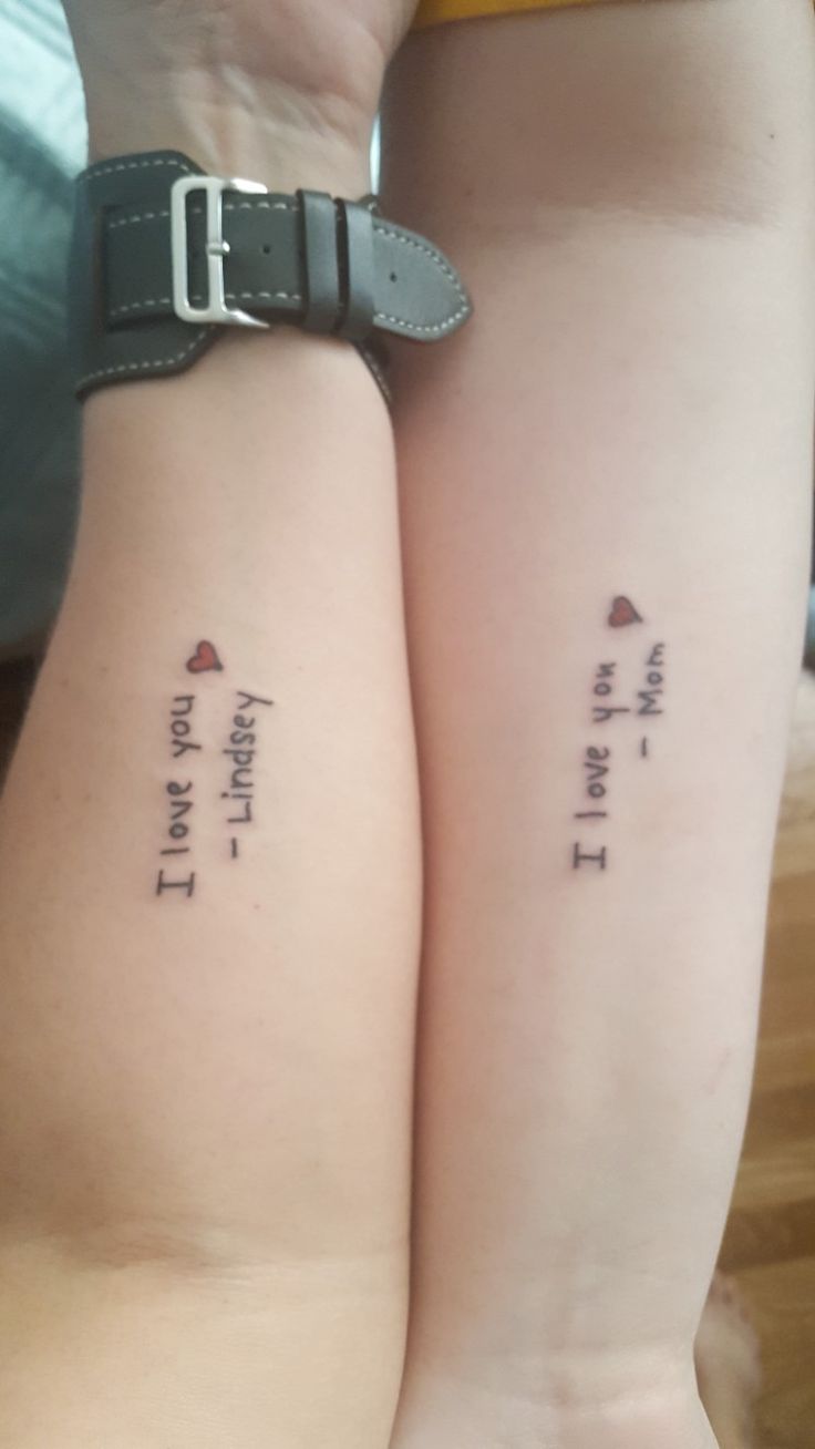 two people with matching tattoos on their arms