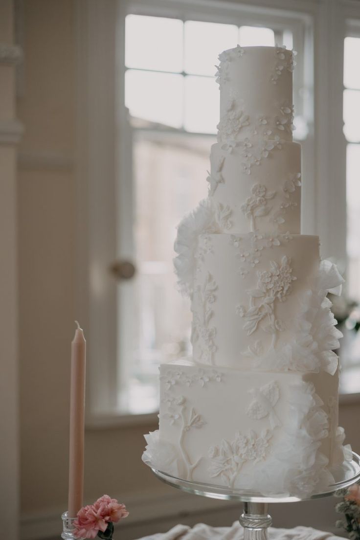 a white wedding cake sitting on top of a table