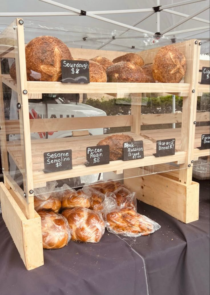 breads and pastries are on display under a tent