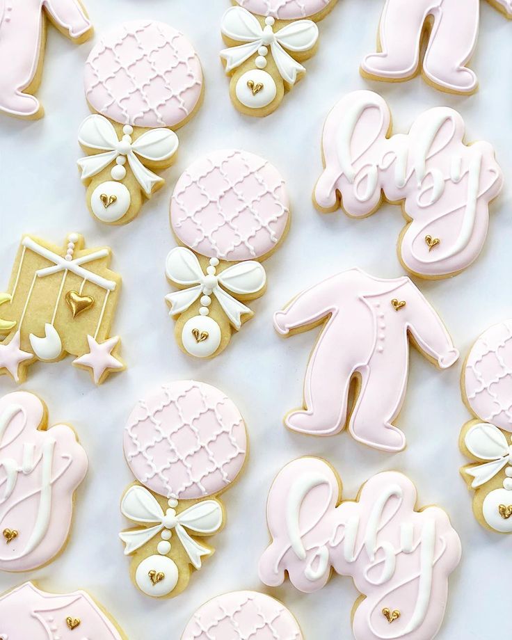 decorated cookies are arranged on a white surface