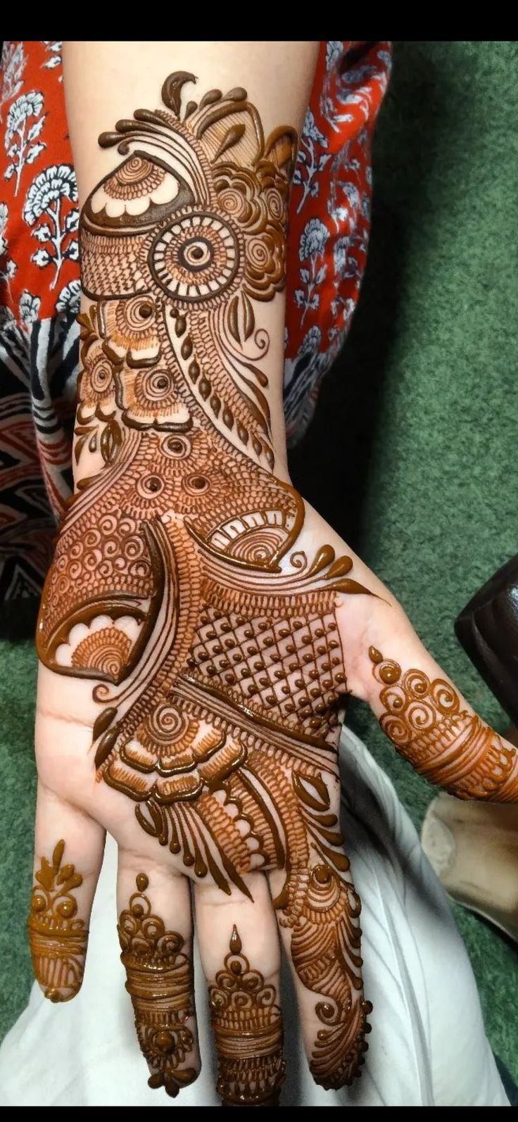 a woman's hand decorated with henna and intricate designs on her hands,