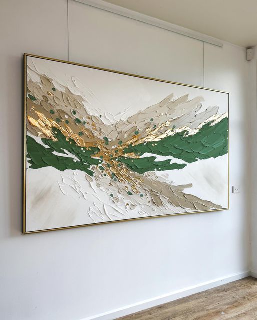 an abstract painting hangs on the wall next to a wooden floor in a white room