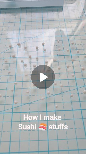 the video is showing how to make sushi stuff with white balls on blue grids