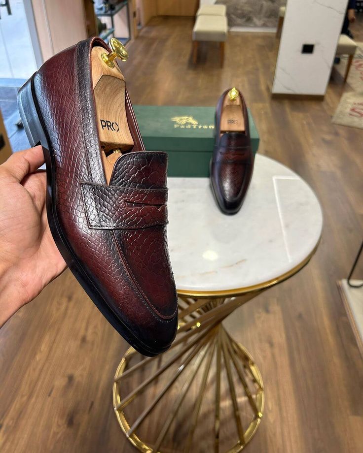 Elevate your executive style with the Prestige Burgundy Penny Loafers. These meticulously handcrafted loafers boast a rich burgundy hue and a distinctive textured leather, showcasing unparalleled craftsmanship. The classic penny loafer design adds a touch of timeless elegance, while the premium leather ensures supreme comfort and durability. These luxury dress loafers are perfect for boardroom meetings or upscale events and make a statement of refined taste and discerning style. Classic Burgundy Dress Shoes For Galas, Classic Burgundy Leather Shoes For Galas, Wingtip Loafers For Semi-formal Occasions, Burgundy Leather Shoes For Office, Classic Burgundy Loafers For Formal Occasions, Burgundy Almond Toe Loafers For Office, Classic Burgundy Loafers For Office, Classic Burgundy Dress Shoes For Semi-formal Occasions, Elegant Burgundy Office Loafers