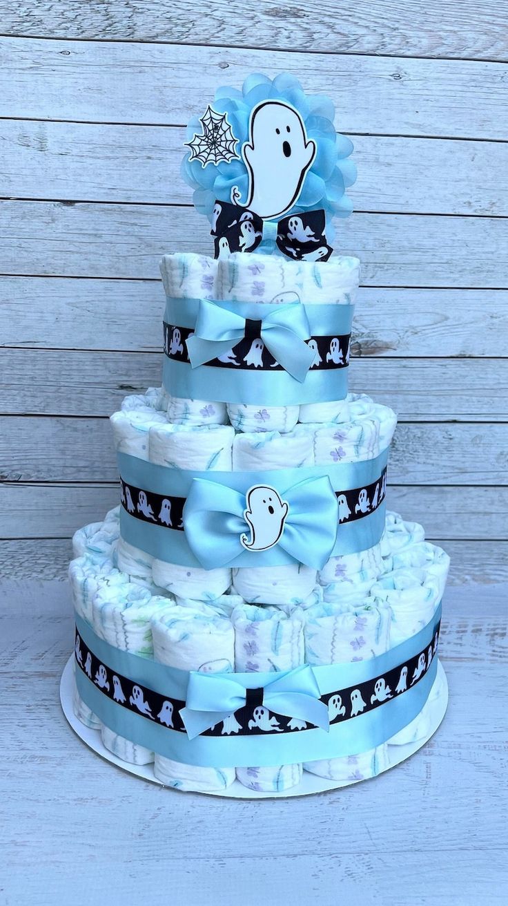 a blue and white diaper cake sitting on top of a table