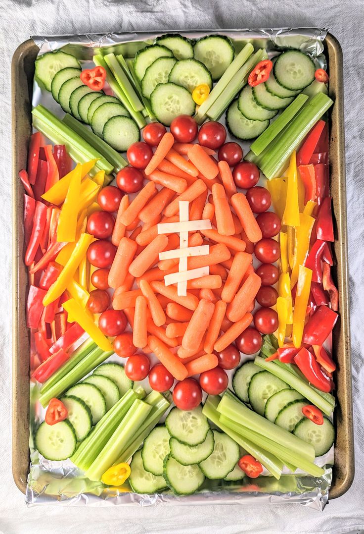 an arrangement of vegetables arranged in the shape of a football