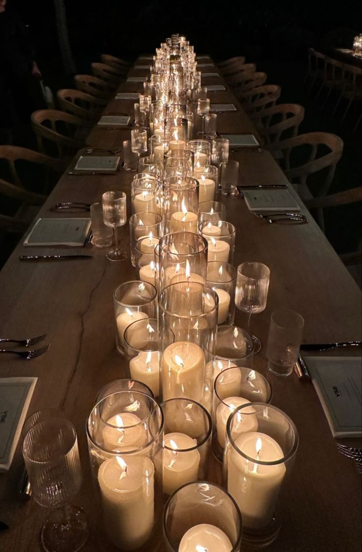 a long table with many lit candles on it