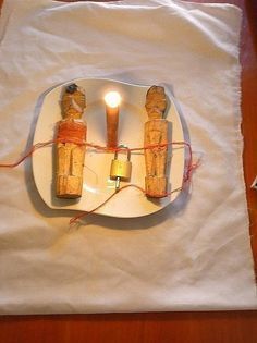 two small candles are on a plate with twine