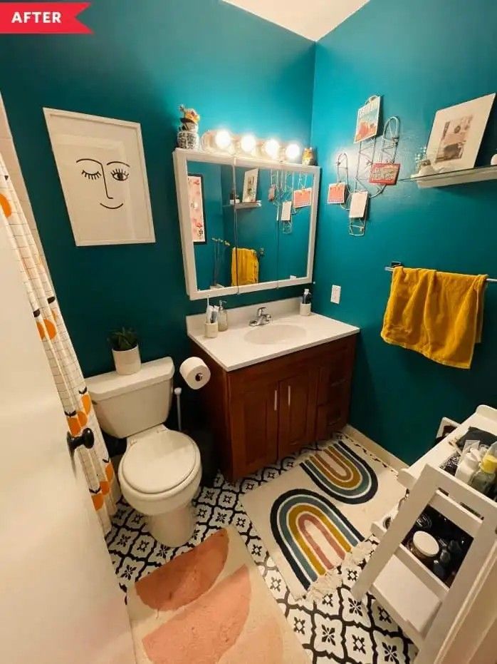 a bathroom with blue walls and colorful rugs on the floor in front of the sink