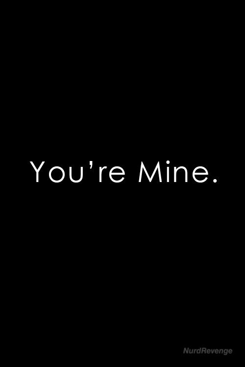 the words you're mine are written in black and white on a dark background