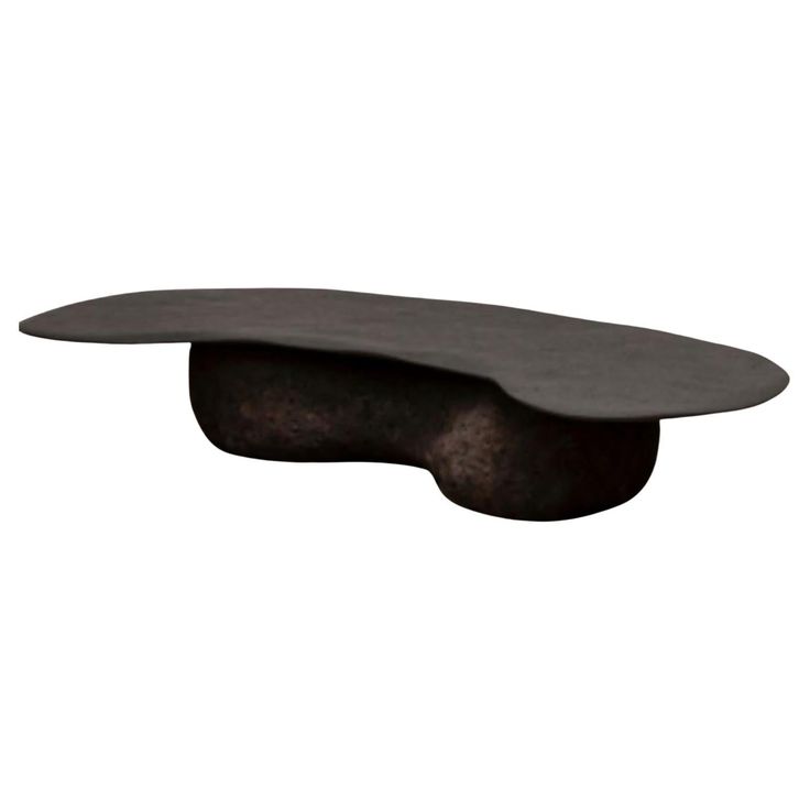 a black table with an oval shaped top and metal base, on a white background