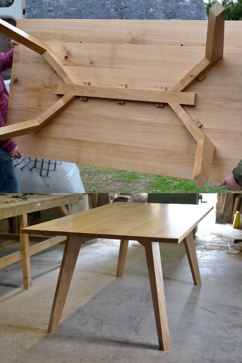 two people working on wooden furniture in a garage