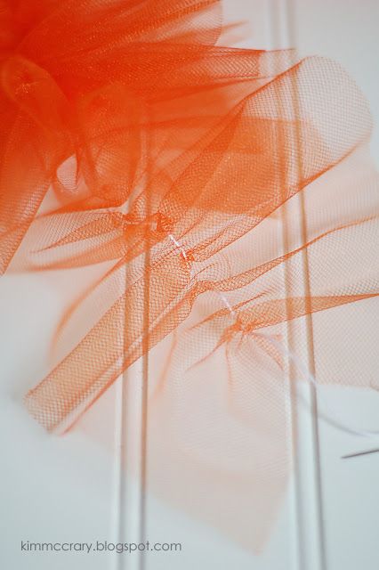 an orange piece of fabric on top of a white table