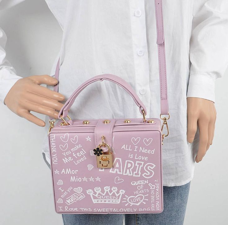 This is a gorgeous unique bag! Makes a great gift item for a young person! 🎁 It has Paris Graffiti printed all over the bag. It’s a studded box clutch with a detachable strap. The strap may be removed and the purse used with or without the strap. The bag is made of polyurethane and mixed metal. The measurements of the bag are: 7.75” width, 6” in height, and 3” in depth. This item ships immediately worldwide! Trendy Box Bag With Detachable Strap As Gift, Trendy Pink Rectangular Case Shoulder Bag, Trendy Rectangular Case Box Bag As Gift, Trendy Rectangular Gift Box Bag, Trendy Rectangular Box Bag With Adjustable Strap, Trendy Box Bag With Adjustable Strap, Trendy Box Bag With Adjustable Strap And Rectangular Shape, Paris Graffiti, Box Clutch