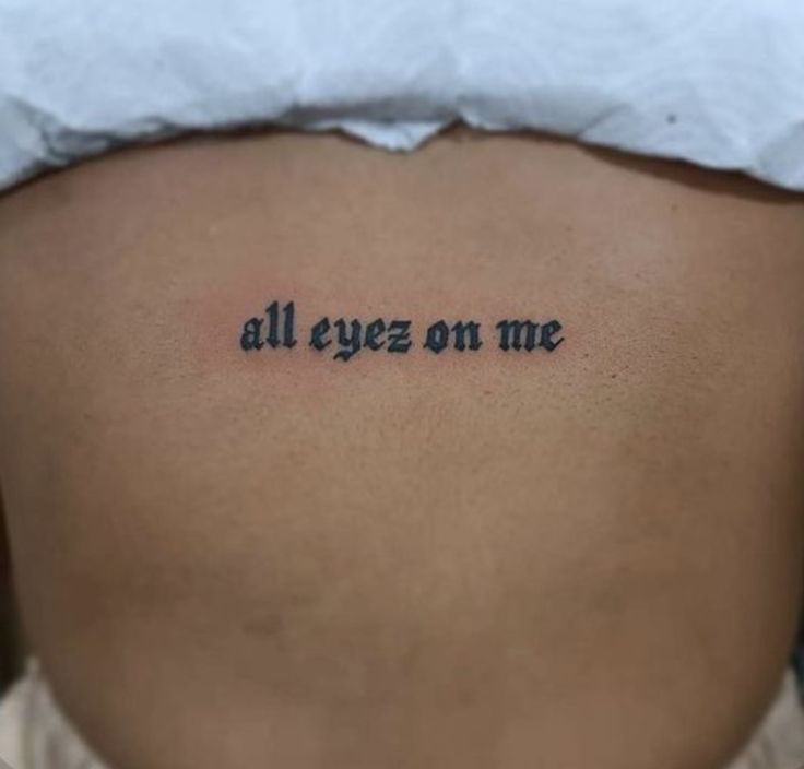 a woman's stomach with the words all eyes on me written in cursive font