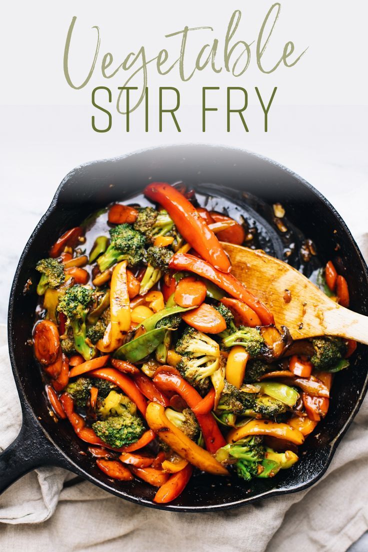 stir fry with broccoli, carrots and other vegetables in a skillet