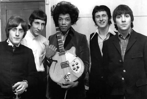 an old black and white photo of the rolling stones holding a guitar in their hands