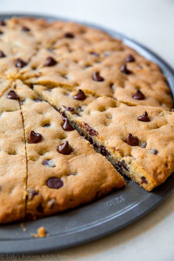 a chocolate chip cookie cake is cut into slices