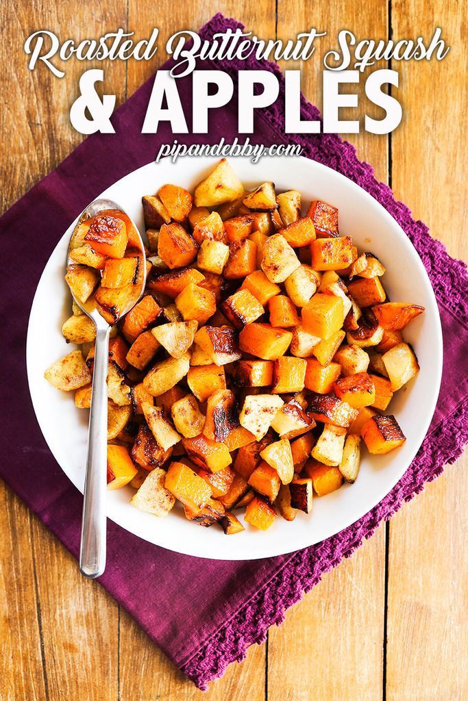 roasted butternut squash and apples in a white bowl on a purple napkin with a spoon