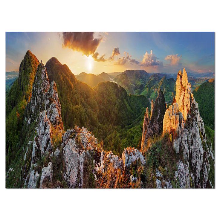 the sun is setting over mountains and valleys in this beautiful landscape with green grass, rocks and