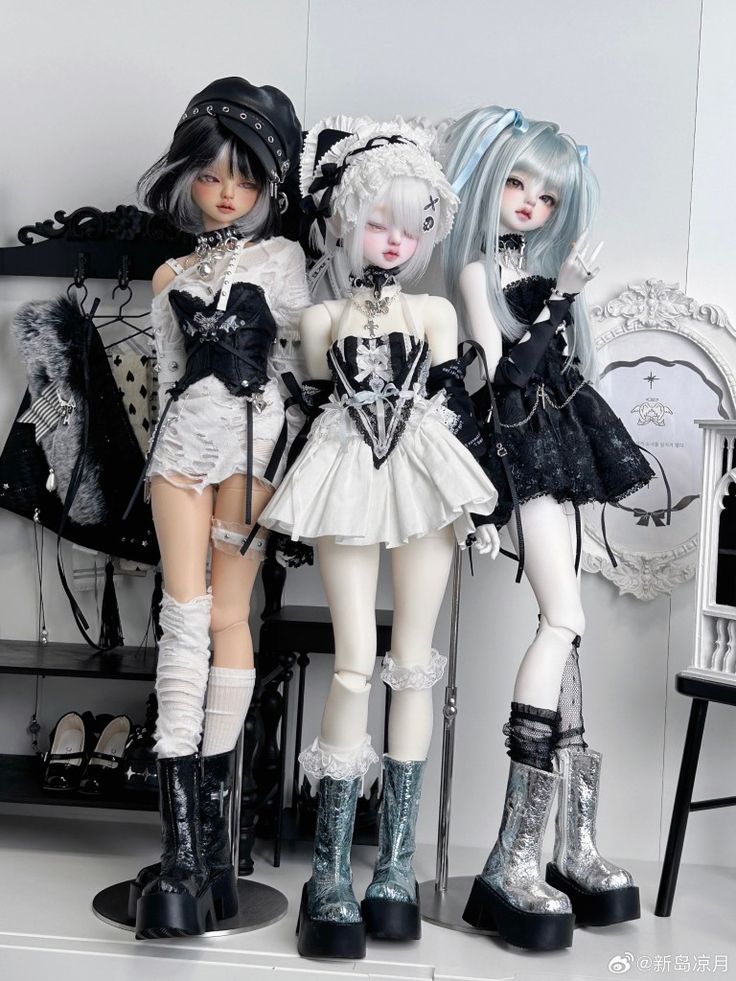 three dolls are posed next to each other