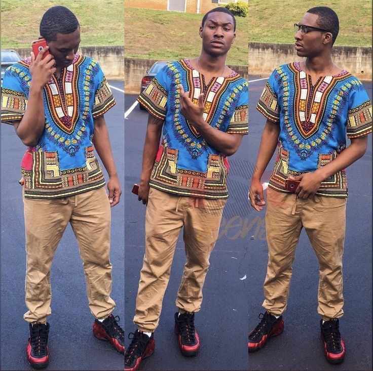 three men in african style clothing standing next to each other and talking on their cell phones