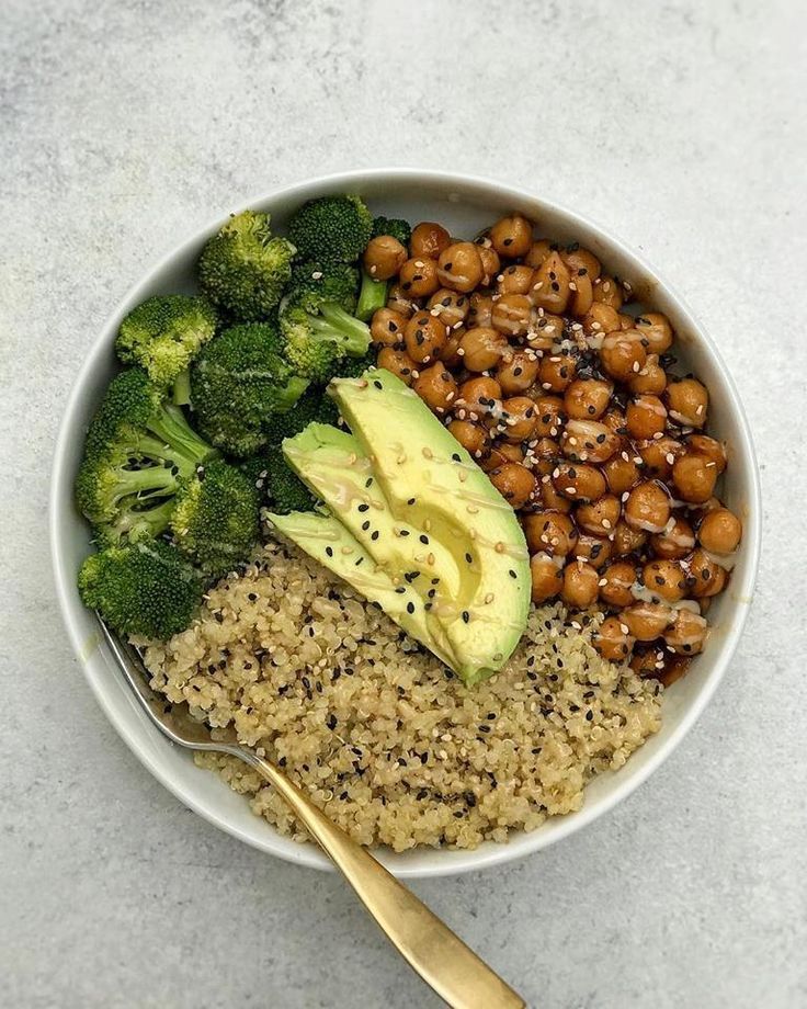 a bowl filled with rice, broccoli and chickpeas