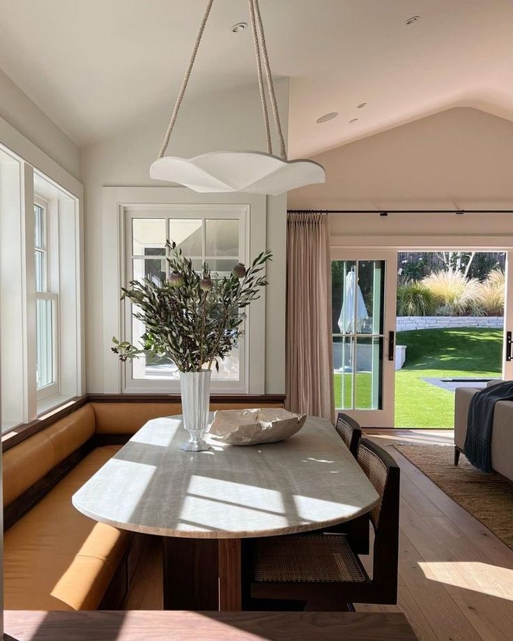 a dining room table with a vase on it