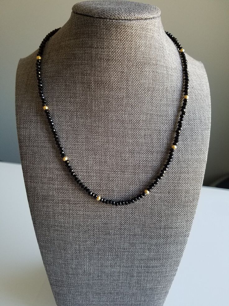 Delicate black spinnel beaded necklace with 24k gold plated spacer beads. Black Spinel is a protective stone that repels negativity and grounds the user while evoking inspiration and empowerment, without overwhelming others. It is also thought to help one find calmness and let go of resentments to re-establish relationships and dispel sadness. Black Beads Daily Wear, Black Beads Necklace Designs, Diamond Black Beads, Beaded Raven, Chrysoprase Necklace, Wedding Necklace Set, Black Gold Chain, Gold Chain Design, Beaded Necklace Designs