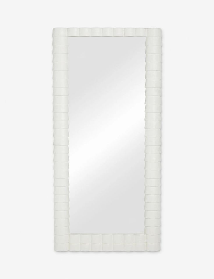 a white rectangular mirror on a wall