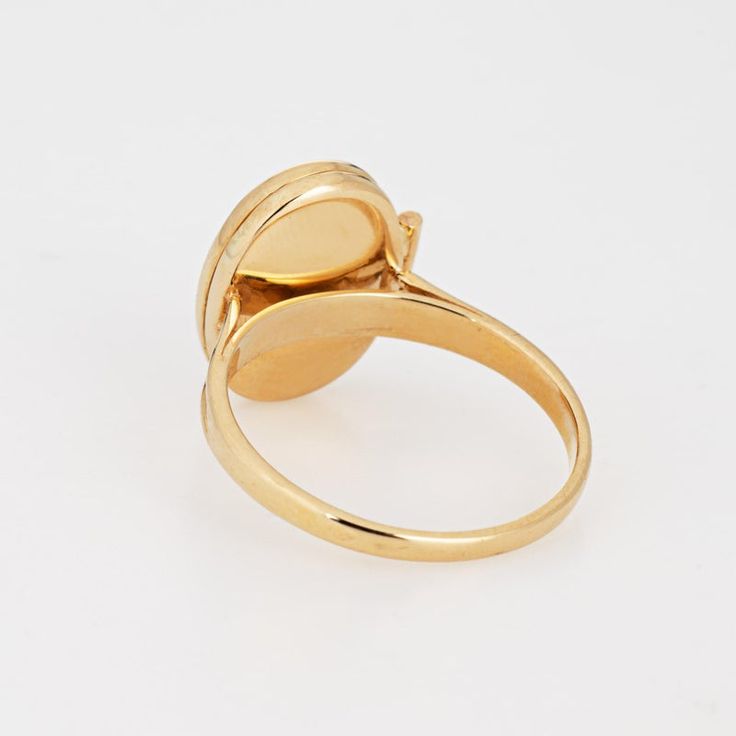 This is part of Chairish’s Fine Jewelry assortment.  Stylish picture locket ring crafted in 14 karat yellow gold.   The oval shaped ring is a wonderful sentimental piece. The locket opens to reveal two sections that can accommodate a picture or keepsake. The low rise ring (5mm - 0.19 inches) sits comfortably on the finger.  The ring is in very good condition and was recently professionally cleaned and polished.   Particulars:  Weight: 3.1 grams  Stones:  N/A   Size & Measurements: The ring is a Yellow Gold Oval Signet Ring With Polished Finish, Oval Yellow Gold Signet Ring With Polished Finish, Antique Oval Signet Ring With Polished Finish, Classic Oval Cameo Rings, Formal Yellow Gold Signet Ring With Oval Cabochon, Oval Cabochon Signet Ring In Fine Jewelry Style, Yellow Gold Oval Cabochon Rings For Formal Occasions, Formal Yellow Gold Oval Cabochon Rings, Cameo 14k Gold Rings For Anniversary