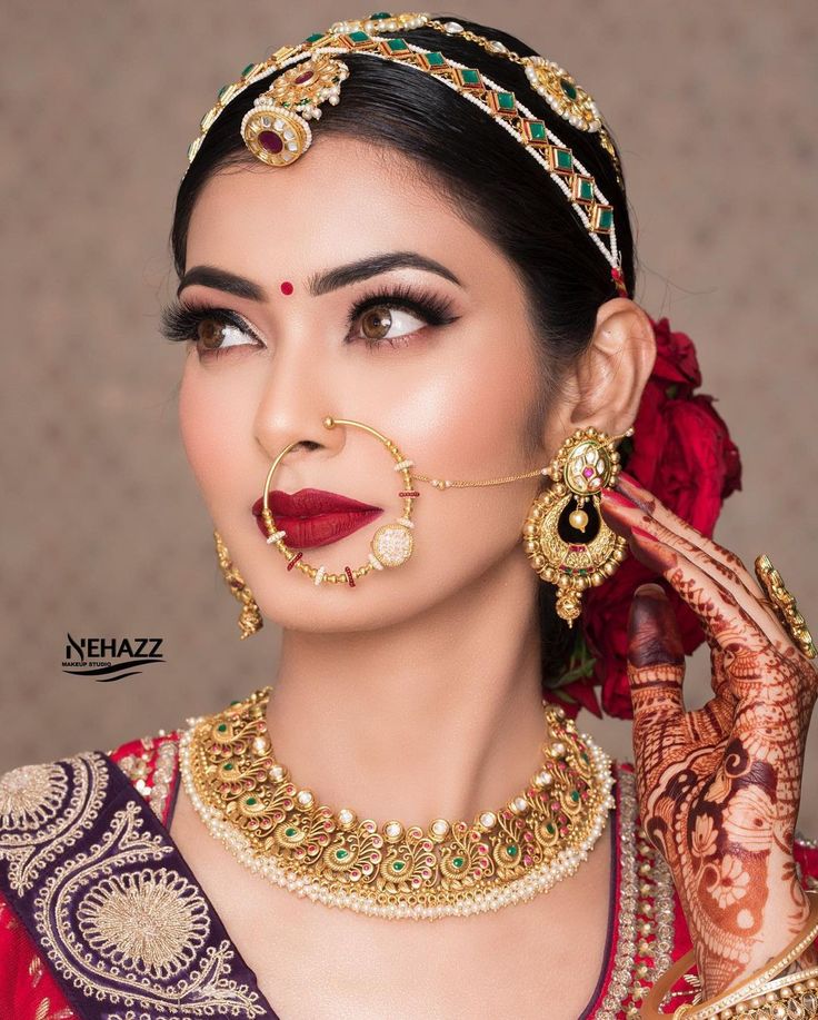 a woman with makeup and jewelry on her face