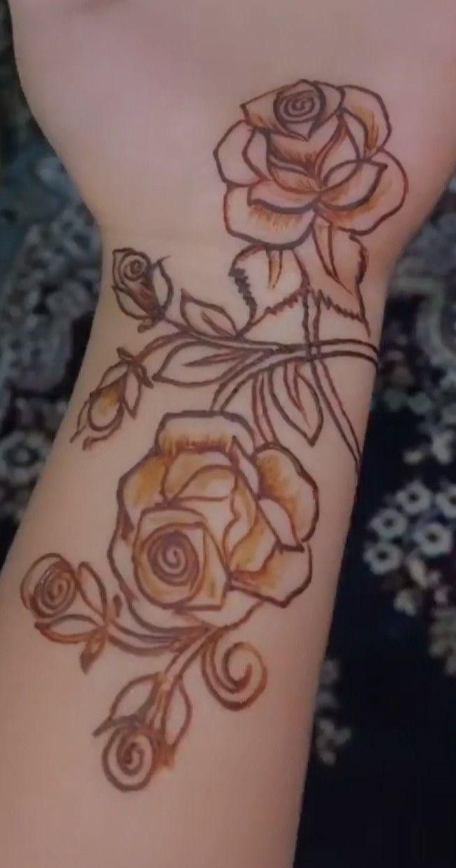 a woman's arm with flowers on it