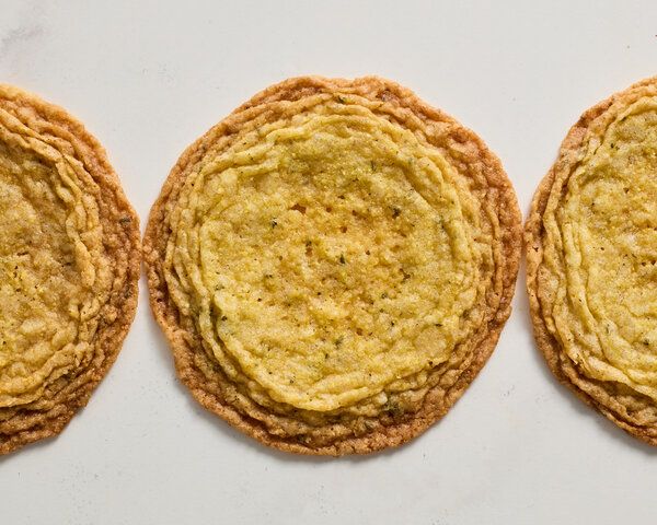 three cookies sitting side by side on top of a white countertop next to each other