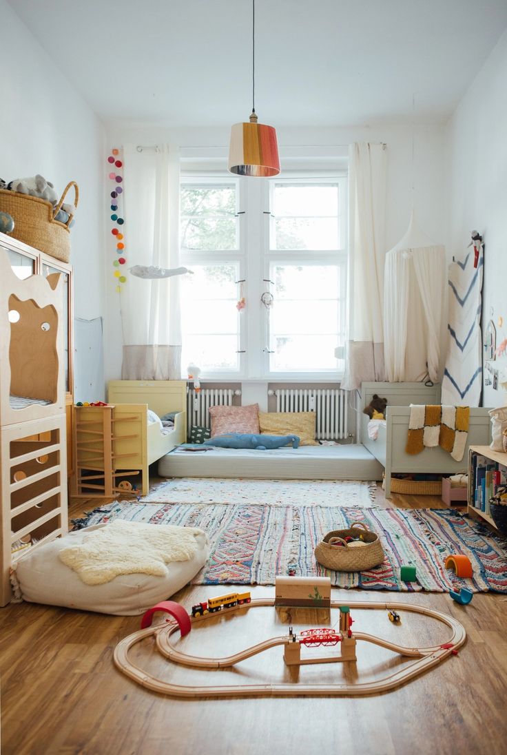 a child's room with toys and furniture in it, including a train set