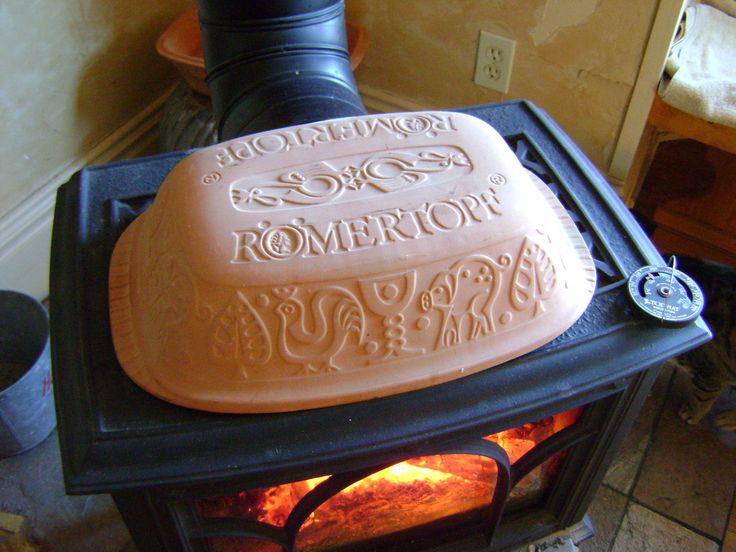 a close up of a stove top with an oven in the middle and words written on it