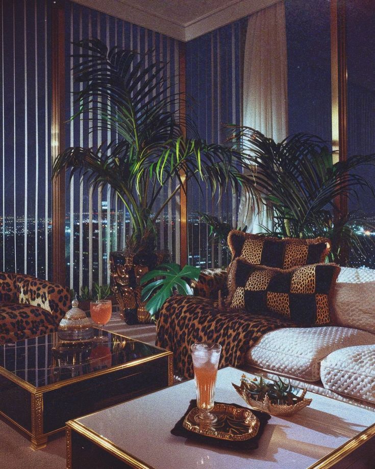 a living room with leopard print furniture and large windows