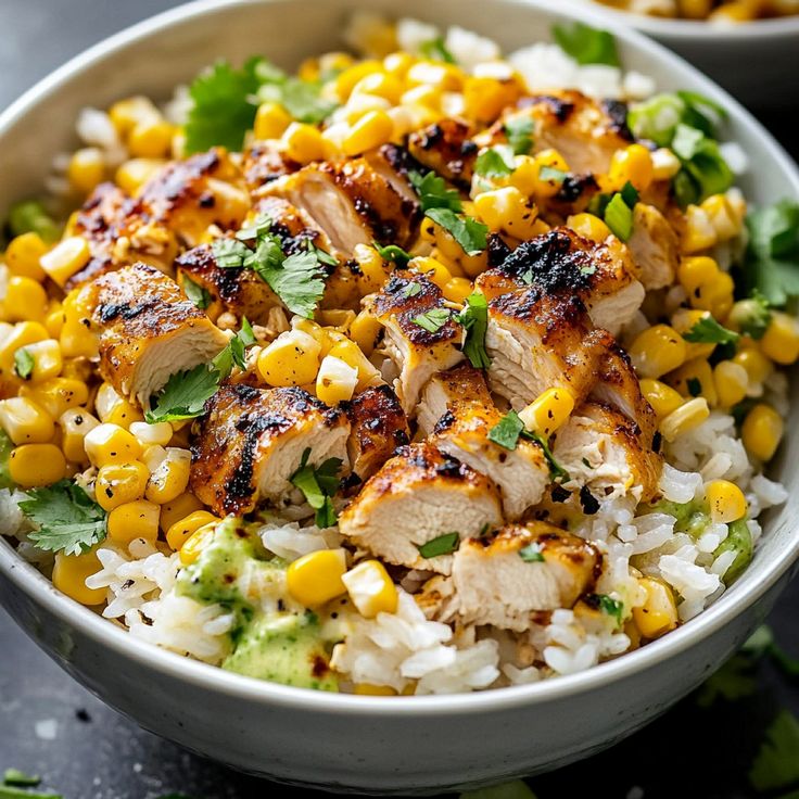 a bowl filled with rice, corn and cilantro