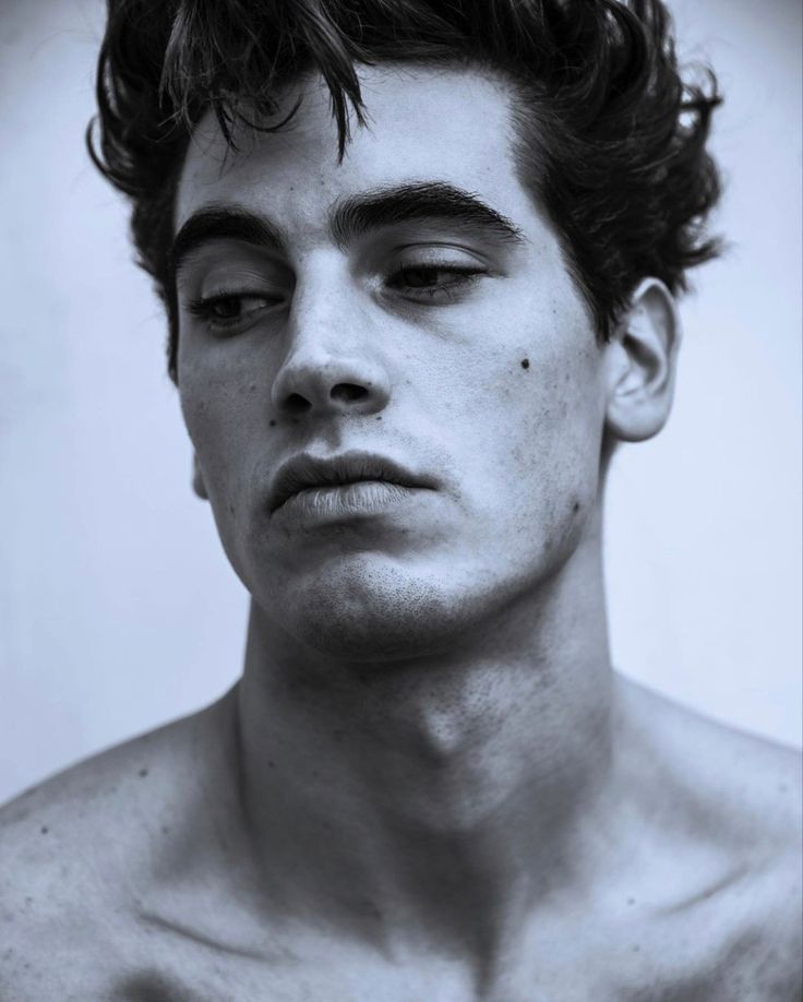 a shirtless young man with his eyes closed