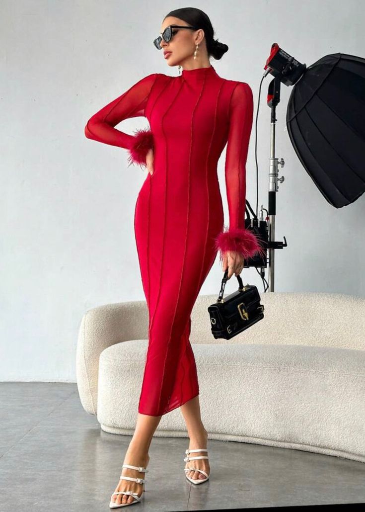 a woman in a red dress holding a camera