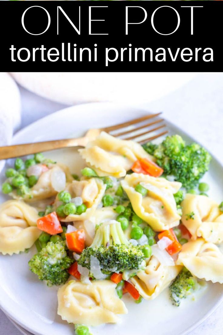 a white plate topped with tortellini shells and veggies next to a fork