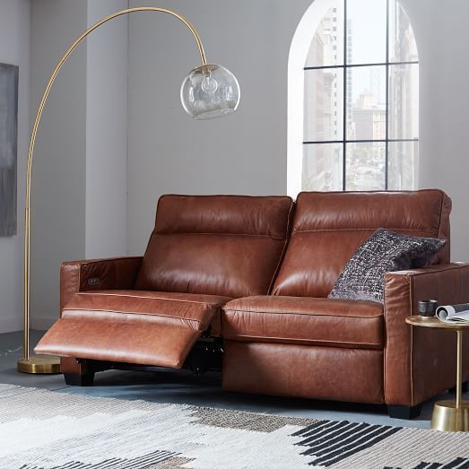 a living room with a brown leather couch