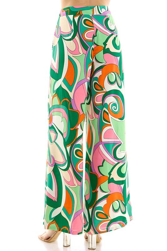 Pucci print, multi color, wide leg, loose fit pant. 100% Polyester Spring Wide Leg Bottoms With Retro Print, Retro Wide Leg Printed Bottoms, Wide Leg Bottoms With Retro Print For Spring, Wide-leg Bottoms With Retro Print For Spring, Printed Ankle-length Wide Leg Pants For Spring, Retro Multicolor Printed Bottoms, Green Bottoms With Vibrant Print For Vacation, Chic Patterned Printed Pants, Chic Printed Patterned Pants