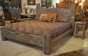 a bed sitting inside of a bedroom on top of a hard wood floored floor